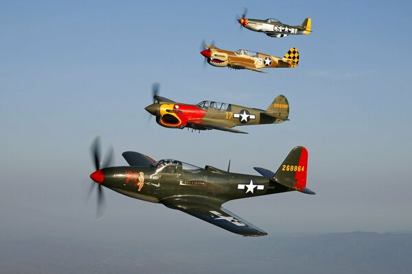 4 fighter jets with colored coloring in the sky