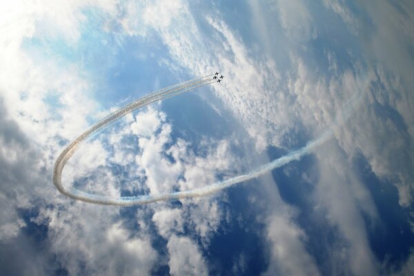 Fighter performs a trick on the background of clouds