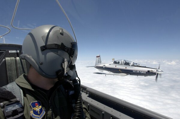 Pilot in a plane at altitude with another plane