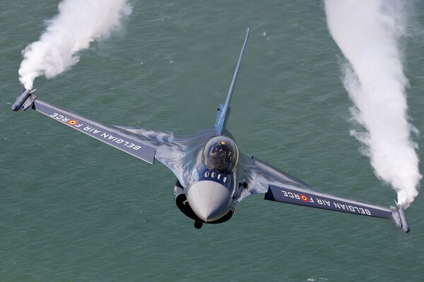 Military fighter over the blue sea