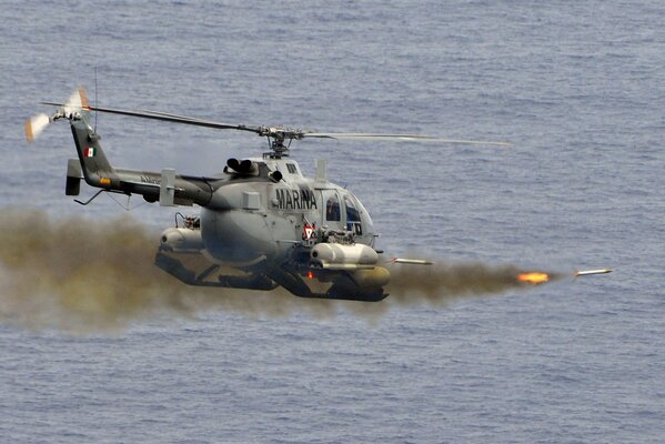 Military helicopter launches missiles