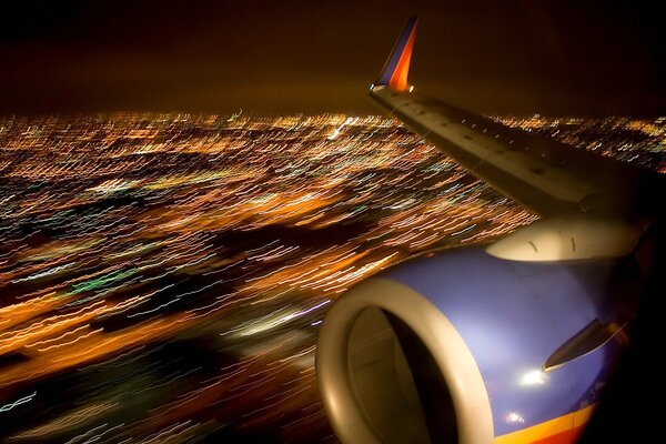 Ala de avión en la ciudad de la noche