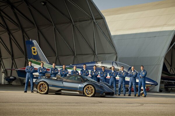 About the pilots in the hangar on the background of the plane