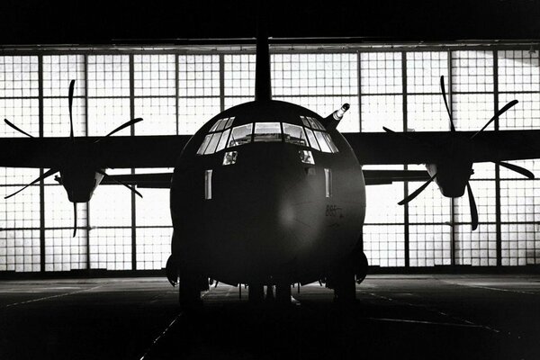 Black and white image of an airplane with two propellers