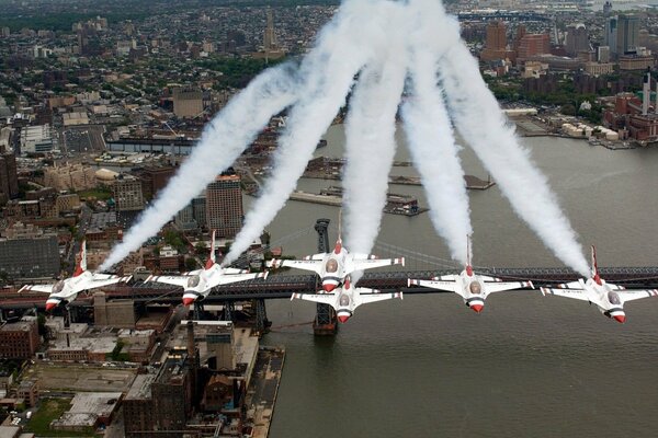 A group of fighter jets fly over the city