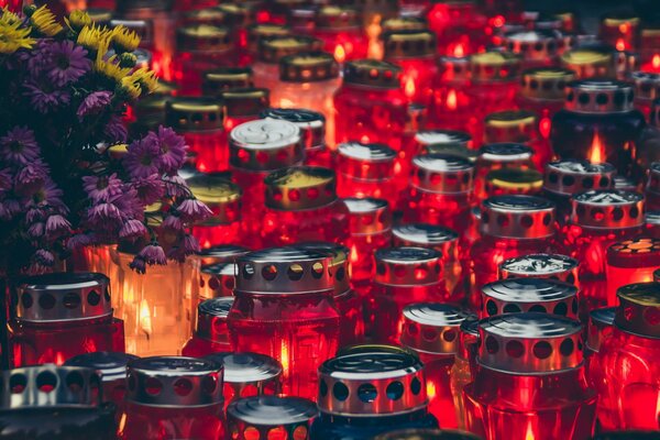 Red and orange candles stand on the surface