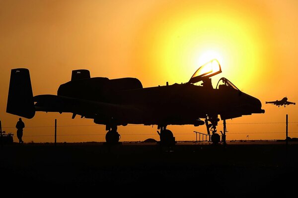 A plane preparing to take off at sunset