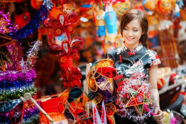 A beautiful girl among bright holiday toys