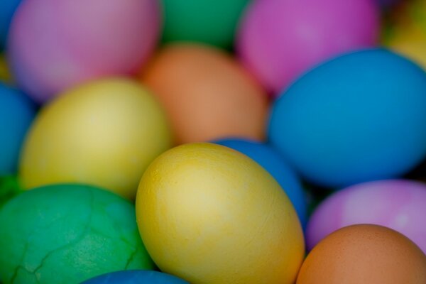 Multicolored eggs, one of them cracked