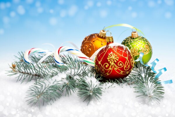 Christmas balls on a snow-covered fir branch