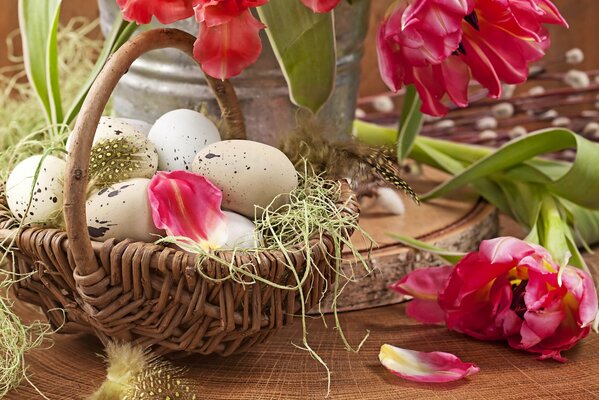 Eggs in a basket on a background of tulips