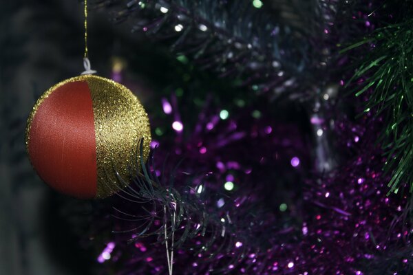 Christmas tree toy on the background of a Christmas tree with garlands