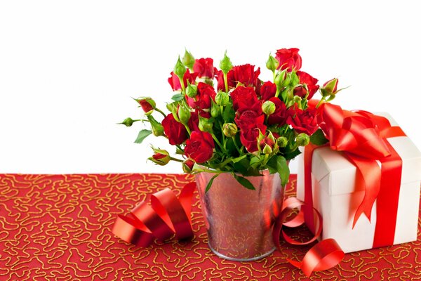 Red roses in a vase and a box