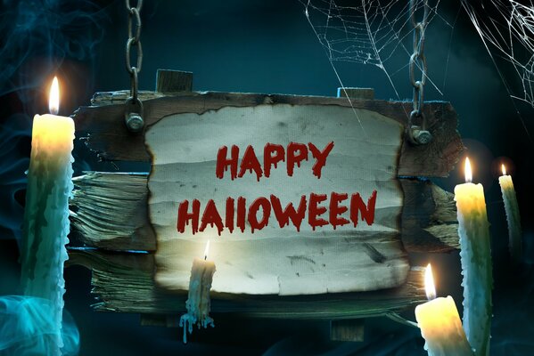 The inscription Happy Halloween next to the candles