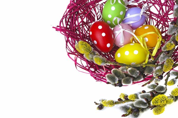 Basket with Easter eggs and willow twigs