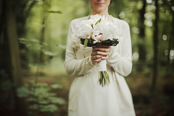 Pivoines blanches dans le bouquet de mariage de la mariée
