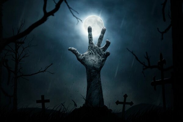 Halloween. Ręka zmarłego na cmentarzu