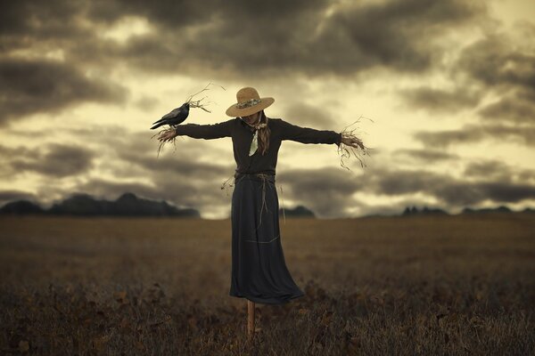 Stuffed girl in a field with a bird
