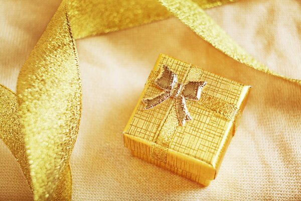 A box with a gold-colored ribbon