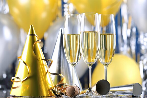 Champagne glasses and festive caps