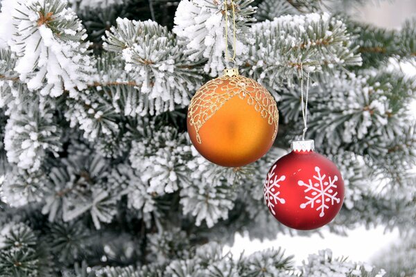 Christmas balls on a snow-covered Christmas tree