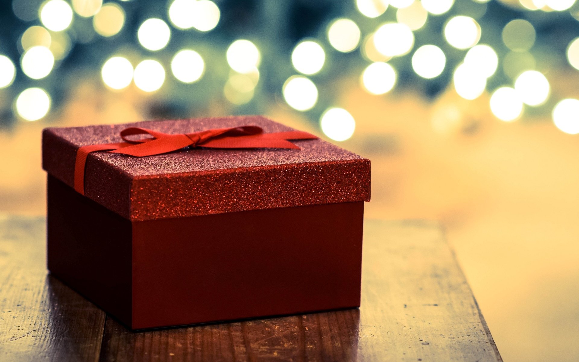 holiday present a present box red belt ribbon blur bokeh new year background wallpaper widescreen full screen hd wallpapers fullscreen