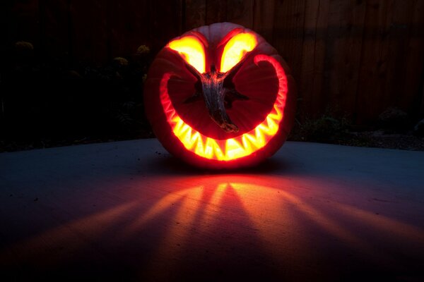 Scary pumpkin glows on the floor