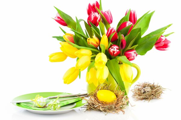 Multicolored tulips with eggs in a nest