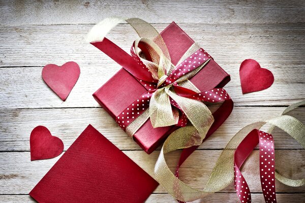 Gift with red wrapping paper and hearts