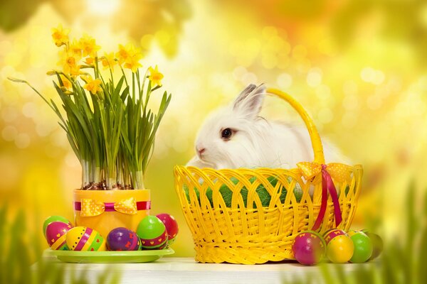 A rabbit in a yellow basket with Easter eggs