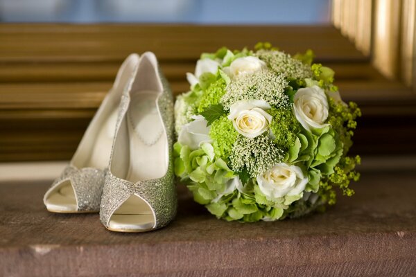 Wedding bouquet and shoes by the window