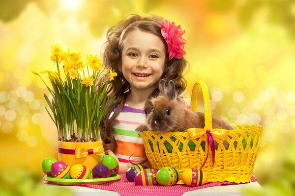 A girl with flowers, Easter eggs and a rabbit