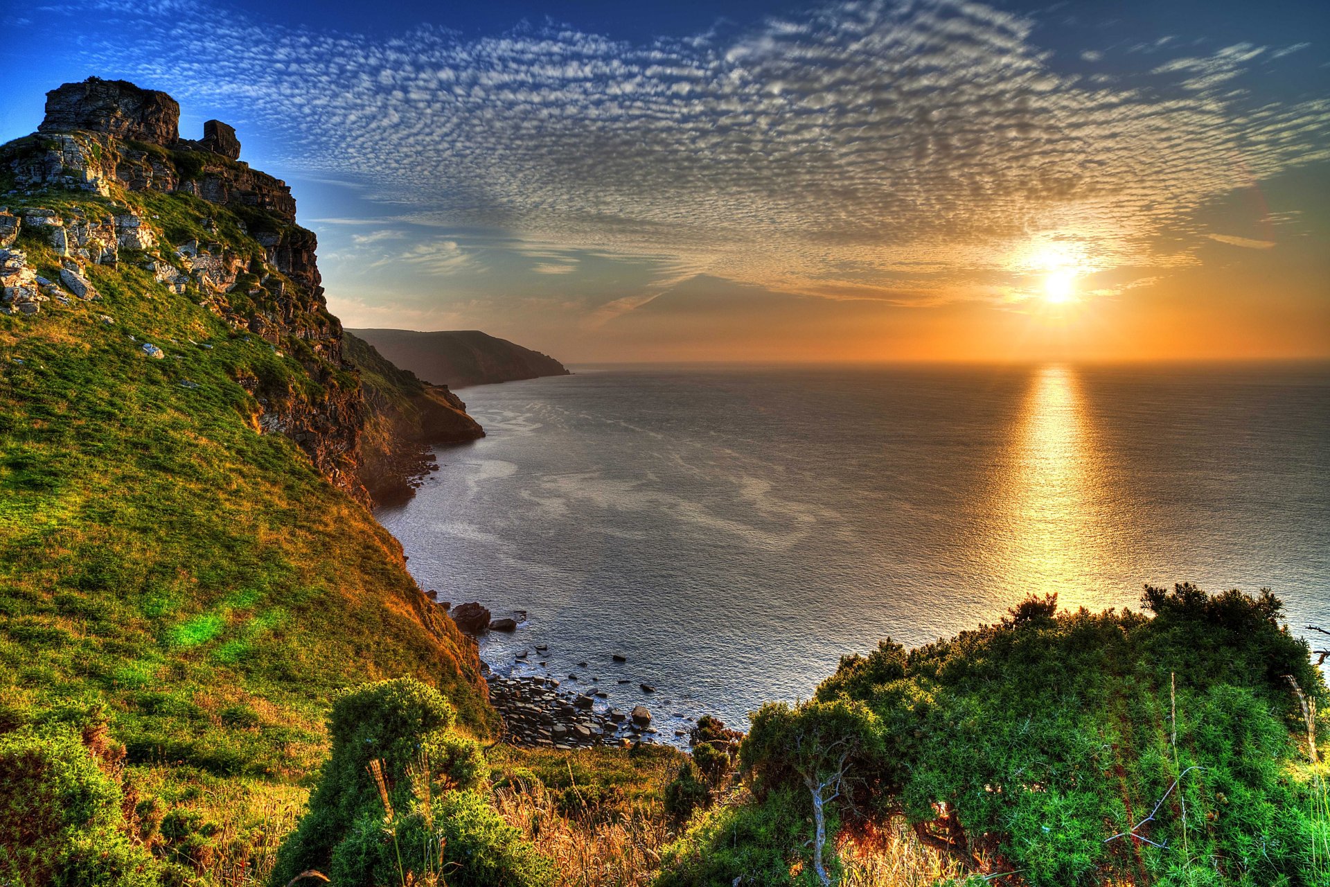 england exmoor national park sea coast stones rock horizon sky sun rays sunset beauty