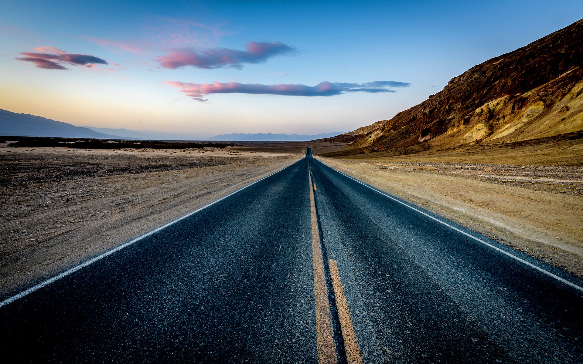 desert highway sand rock mountain dusk sunset road