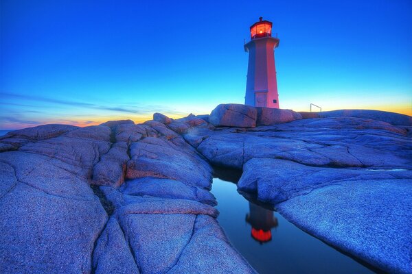 Lighthouse on the rock water Reflection of the lighthouse stones