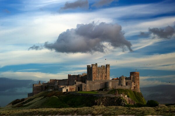 Huge clouds over the castle mountains sea