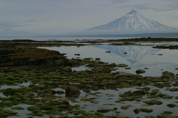 Photo of a mountain reflected in the water