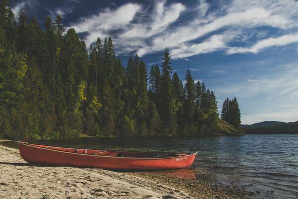 Red boat on the sandy shore