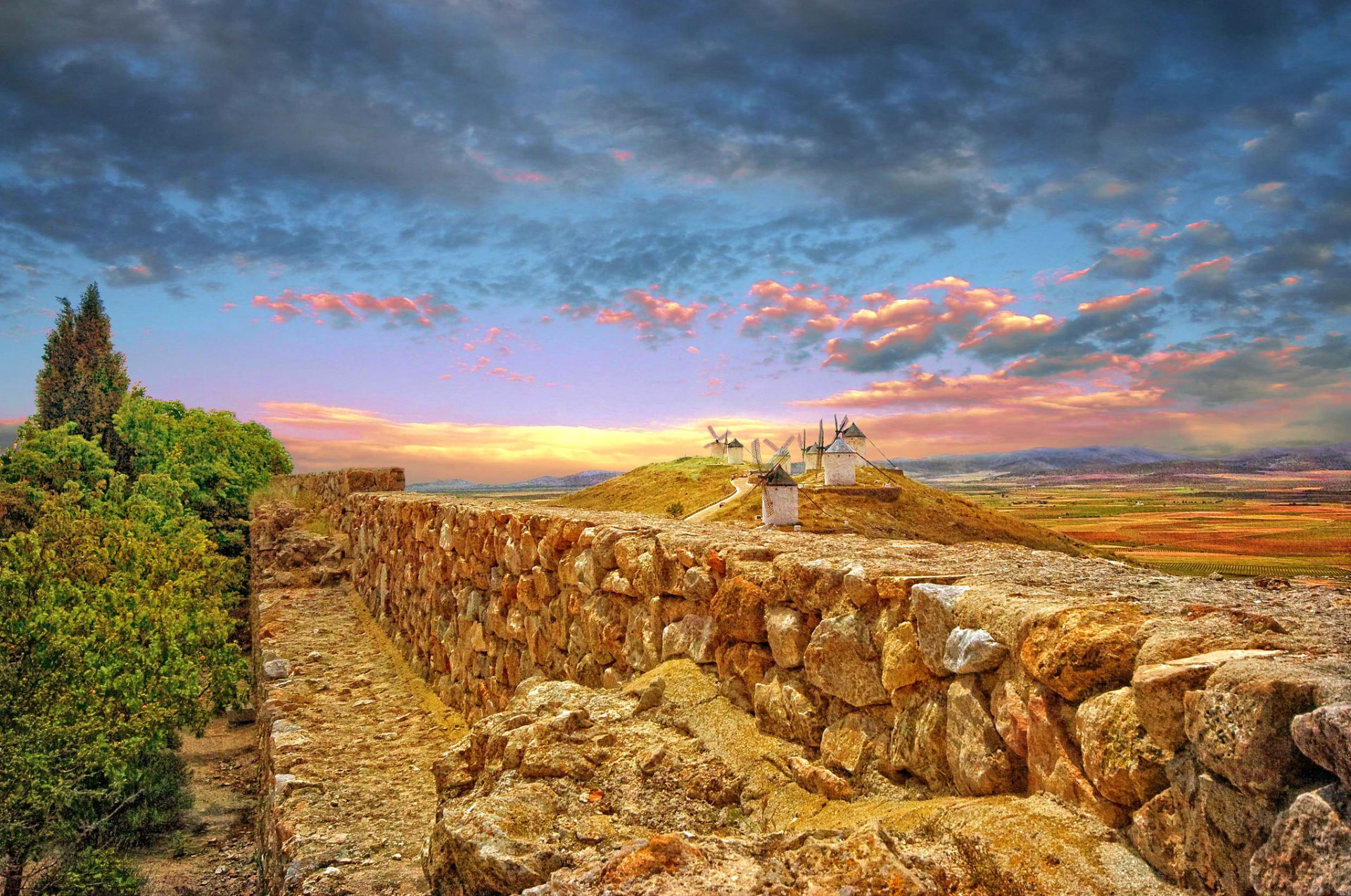 pain sky clouds fence windmill hills mountain