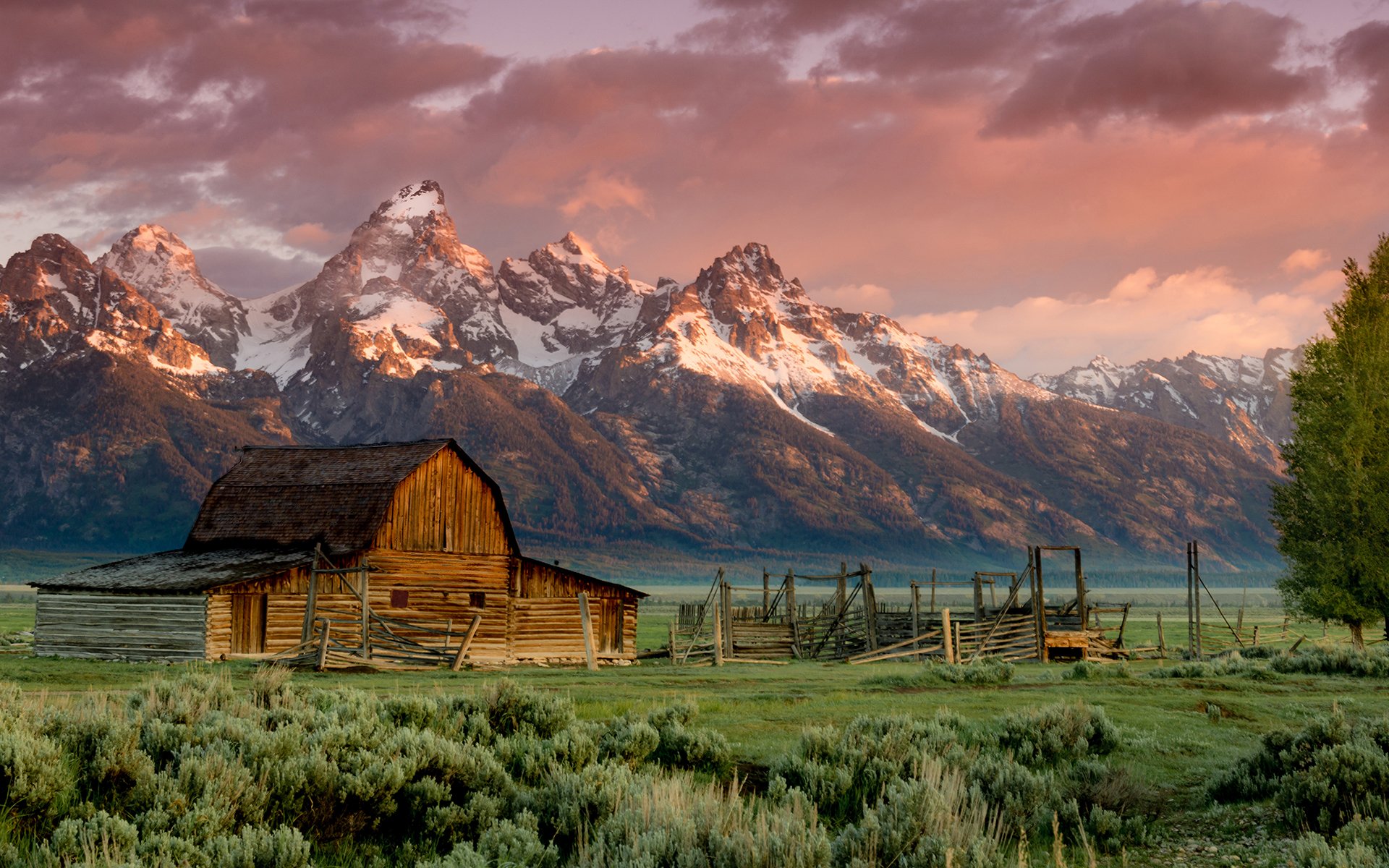 granero teton montañas rocosas puesta de sol hierba