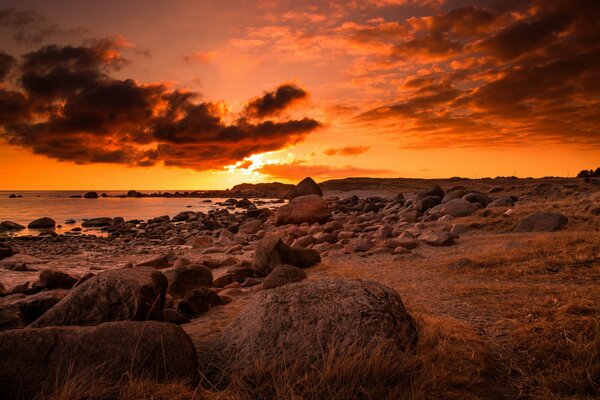 Sunset on the ocean with a rocky shore