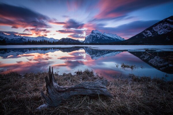 Morning mountains in the snow by the lake