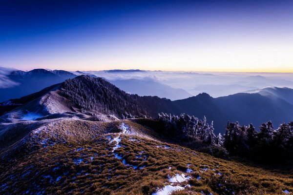 At the top of a mountain landscape