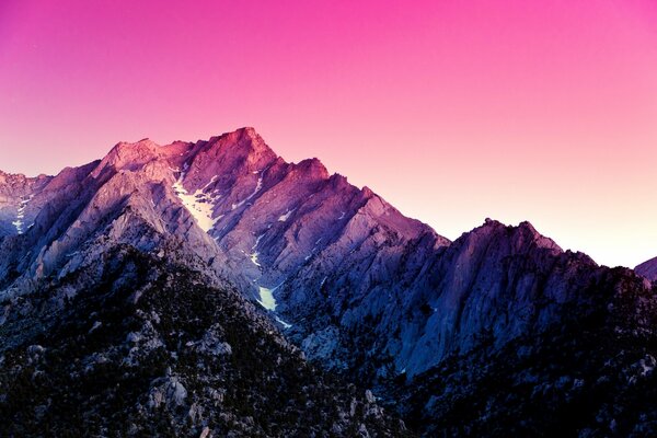 A mountain range on a pink background