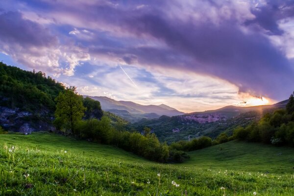 Sunset on a green mountain slope