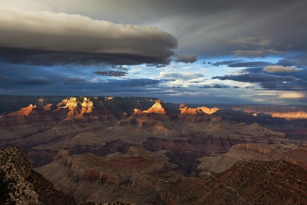 Clouds hung over the canyon. A clear sky is peeking through