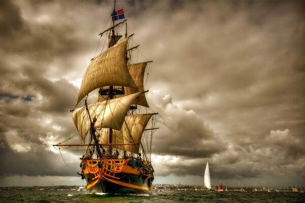 A ship is sailing against the background of storm clouds