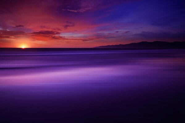 The purple expanse of the ocean at sunset