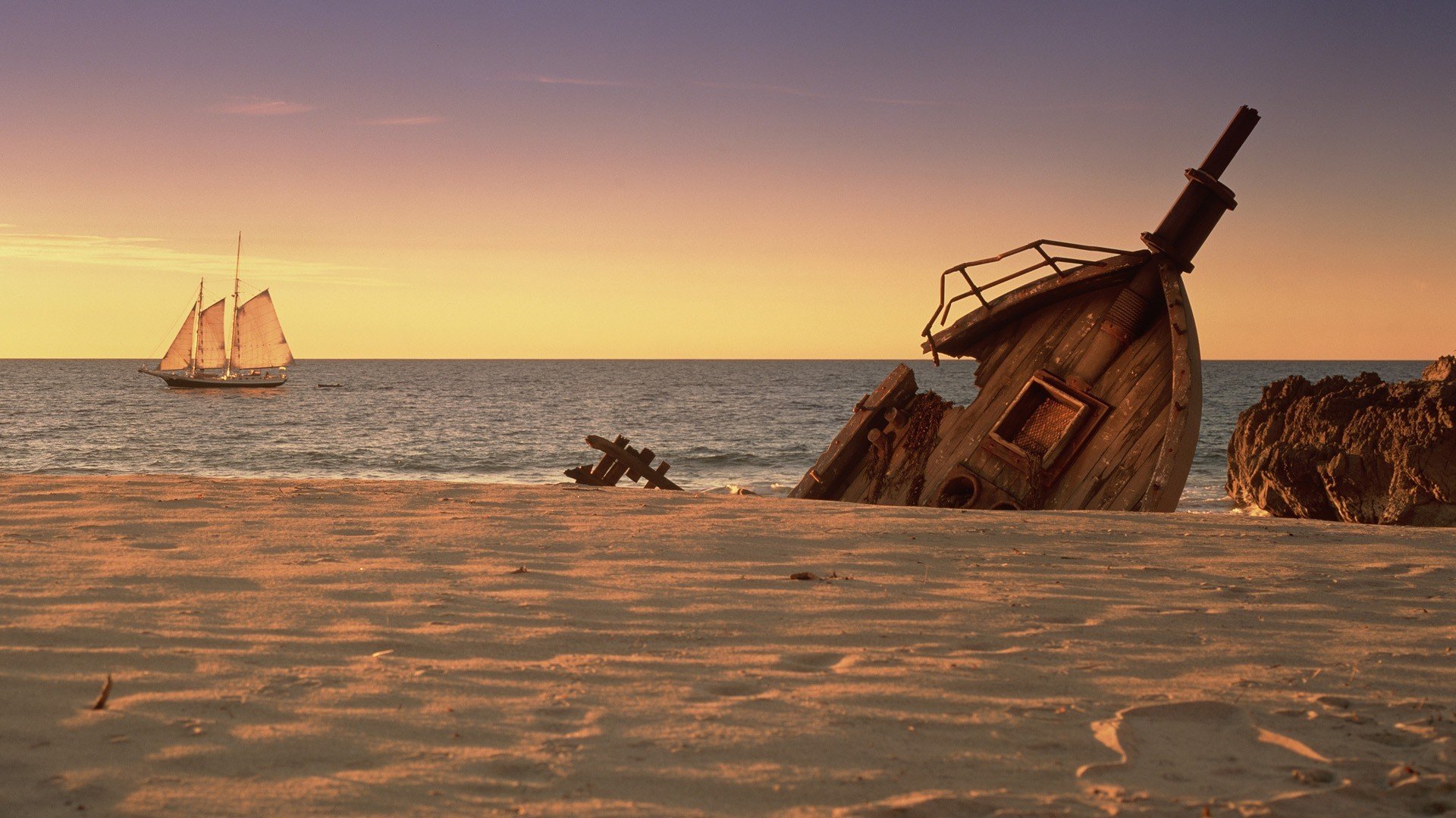 coast ships remains sailboats sea sand boulder