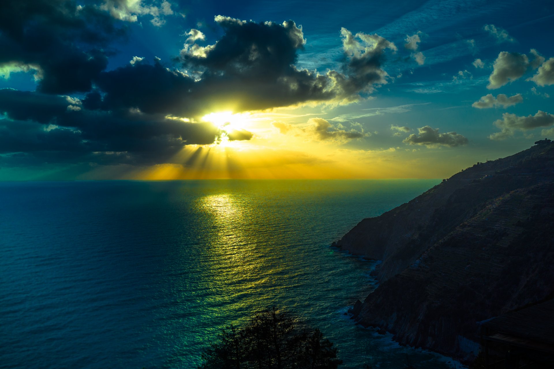 ocean sky clouds sun rays mountain horizon